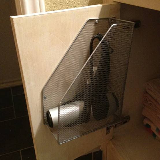 20+ Creative Uses for Magazine Holders to Organize Your Home --> Use magazine holder to hang up the hairdryer