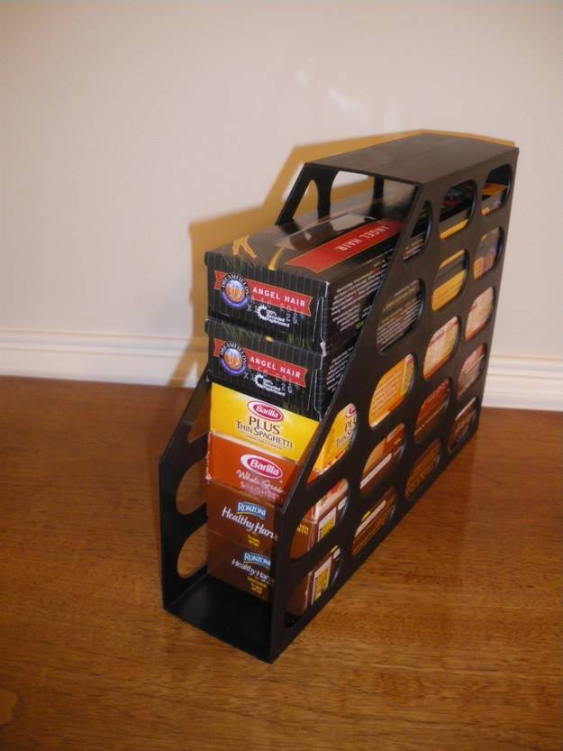 20+ Creative Uses for Magazine Holders to Organize Your Home --> Stack spaghetti boxes in a magazine holder to keep them in place