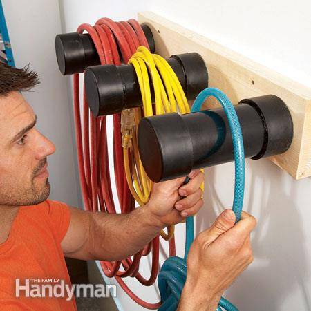 30+ Creative Ways to Organize Your Garage --> Build plastic pipe hangers to store electrical cords and hoses