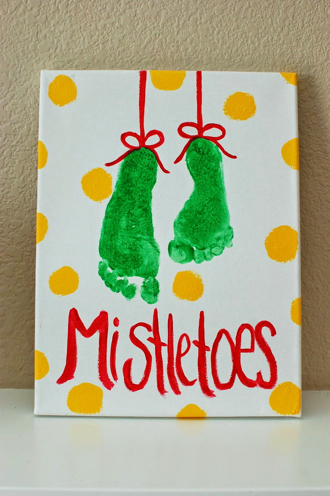 40+ Creative Handprint and Footprint Crafts for Christmas --> Footprint Mistletoe Art Project