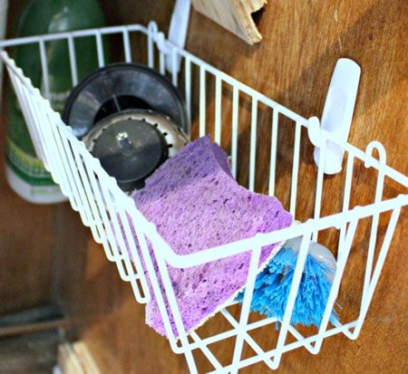 40+ Organization and Storage Hacks for Small Kitchens --> Take advantage of the vertical space under the sink with two Command hooks and a small plastic basket