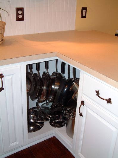 40+ Organization and Storage Hacks for Small Kitchens --> Turn awkward corner cabinet into a pot rack cabinet using hooks