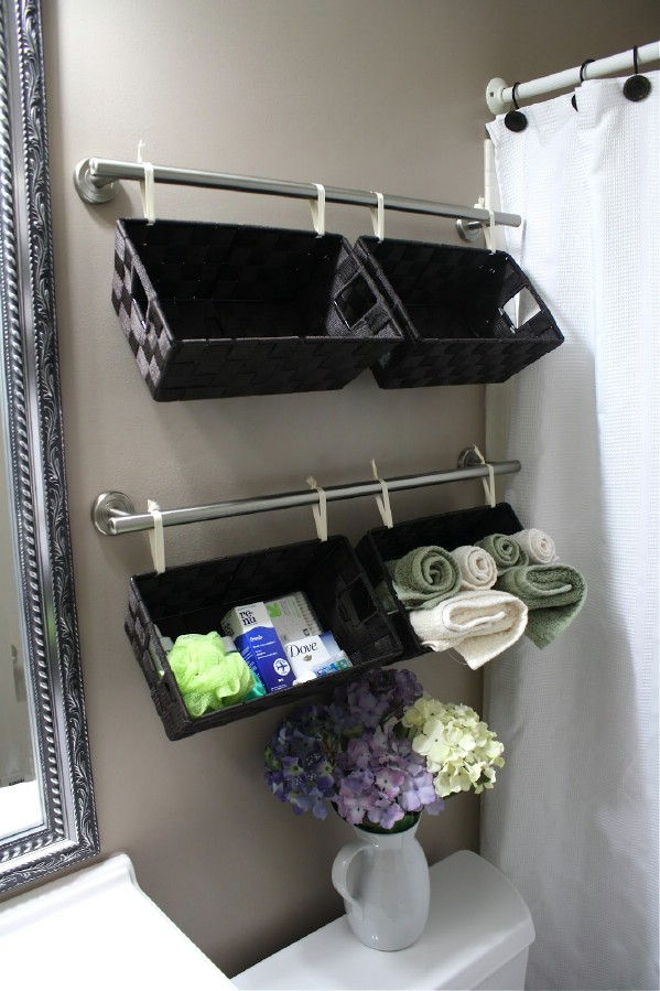 40+ Brilliant DIY Storage and Organization Hacks for Small Bathrooms --> Install towel bars over the toilet to hang baskets for extra storage space