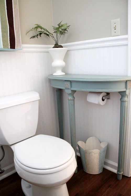 40+ Brilliant DIY Storage and Organization Hacks for Small Bathrooms --> Attach a half table over the toilet paper holder for extra storage