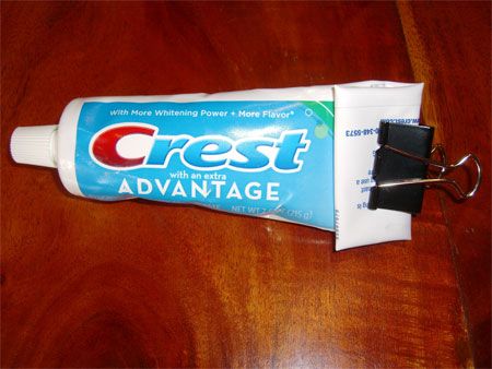 Use a binder clip as a toothpaste squeezer
