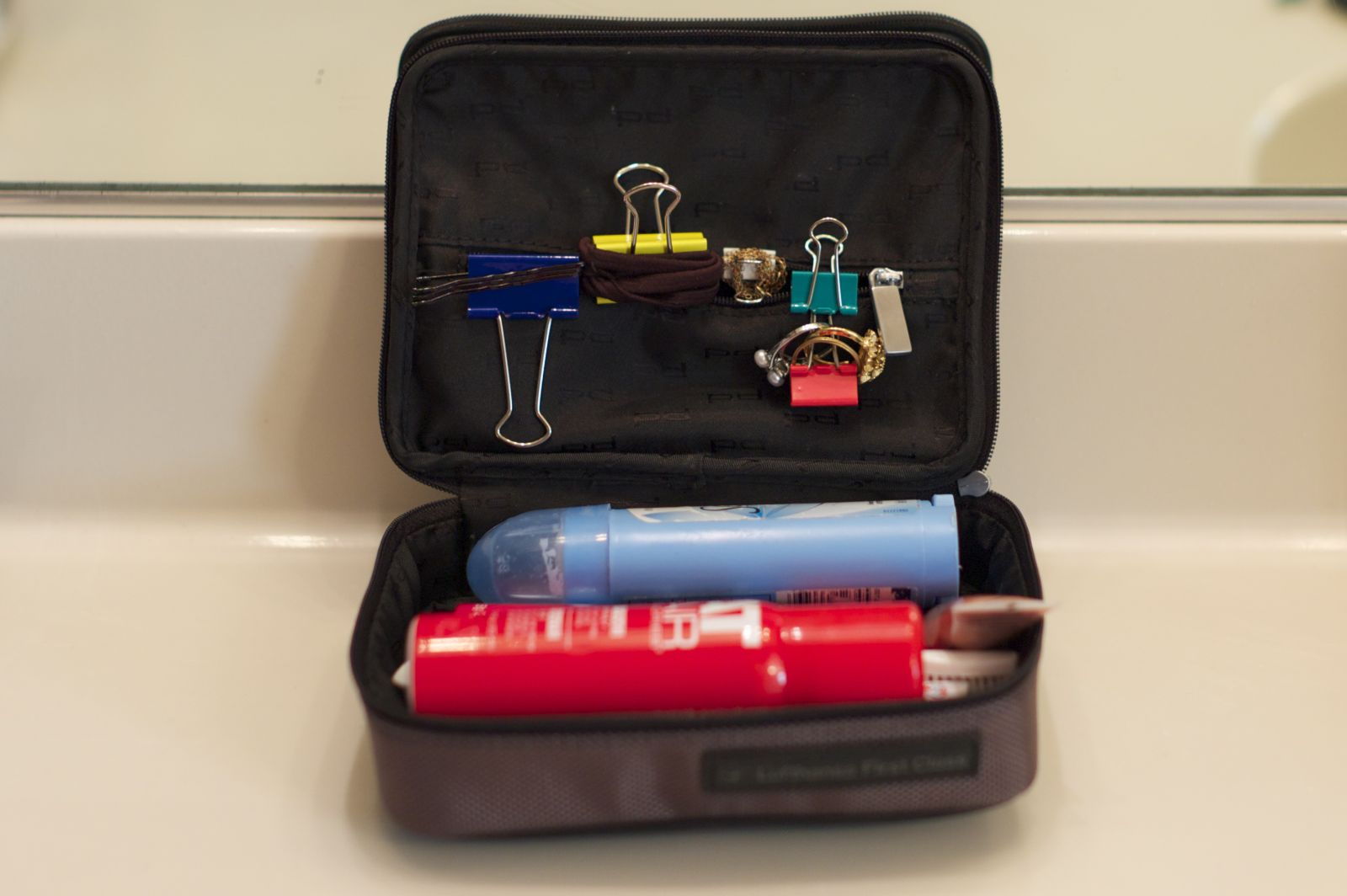 Attach binder clips to the inside of a travel bag to organize your accessories while travelling