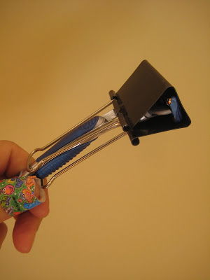 Use a binder clip as a razor cover to protect from unexpected cuts